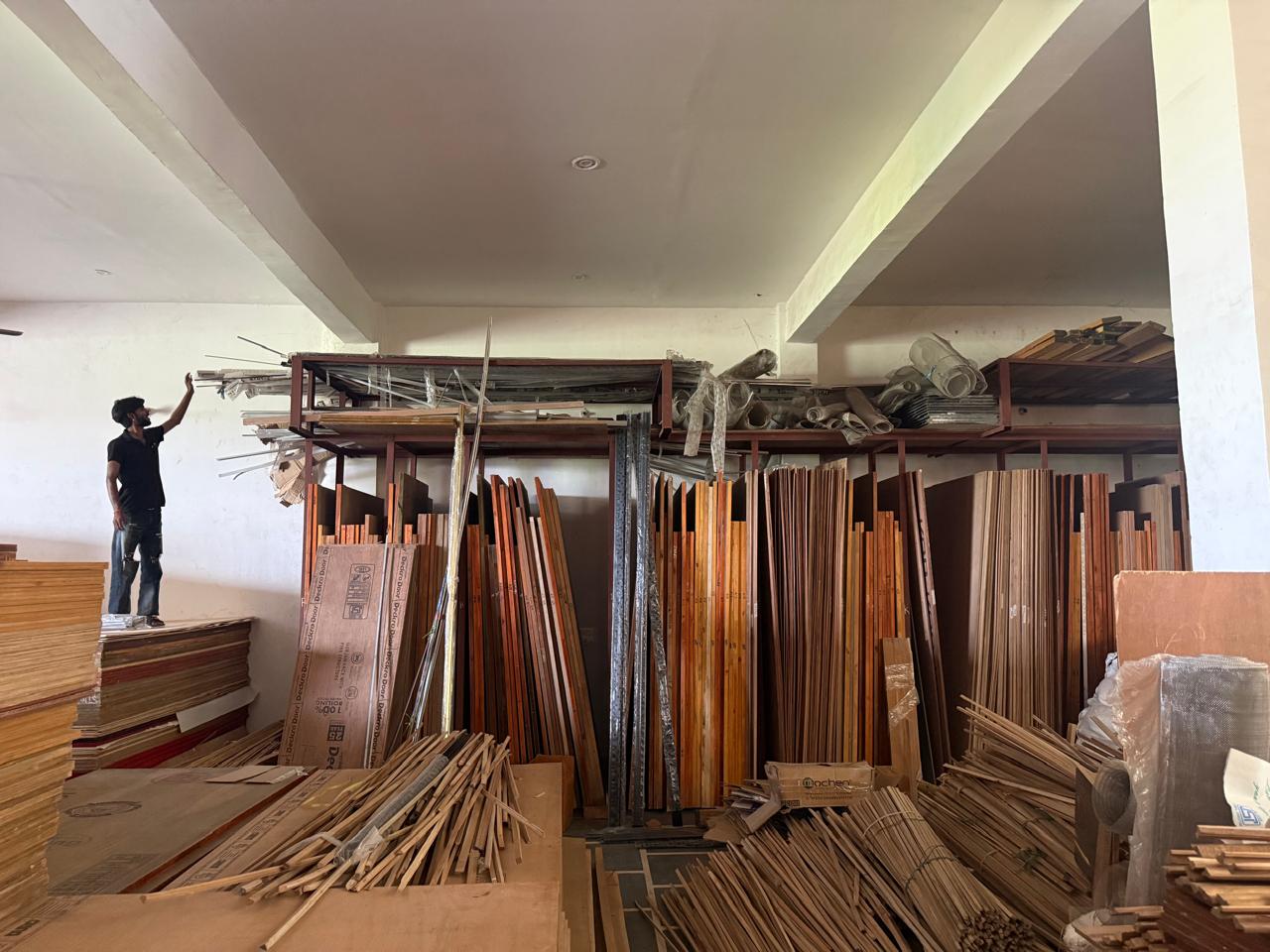 Staff organising plywood and timber in warehouse