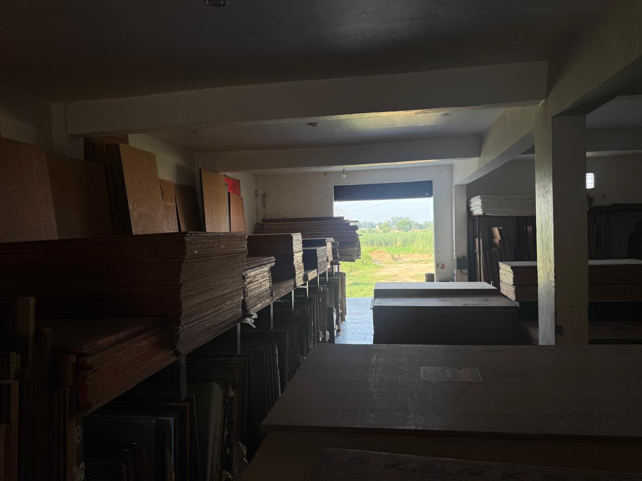 Wide warehouse view full of plywood sheets